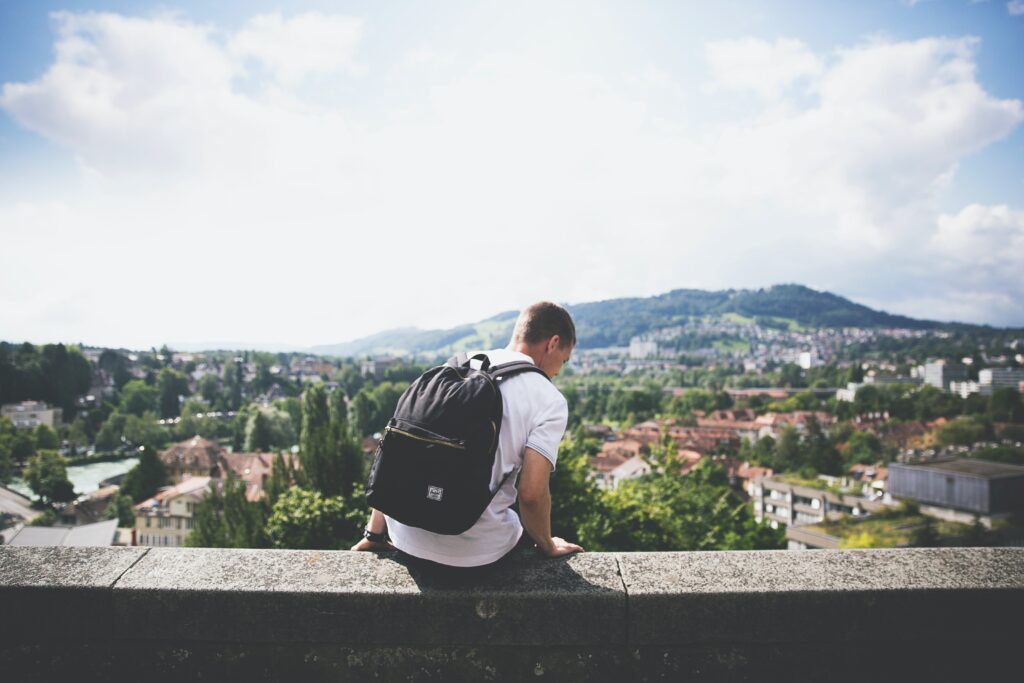 Man sitting on balcony, mountain view